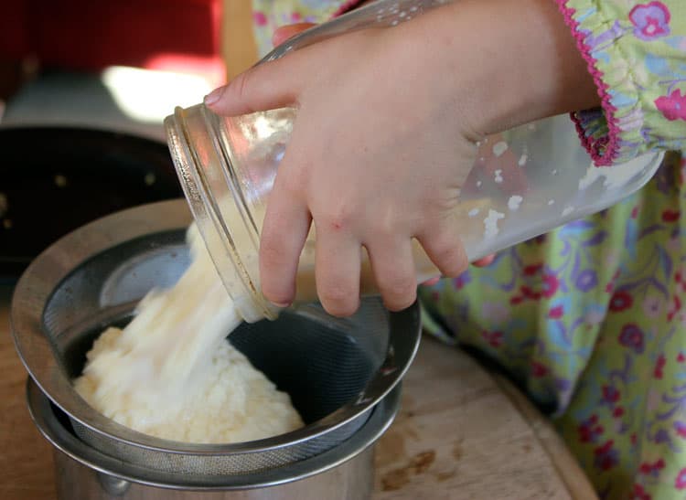Butter pouring into a strainer.