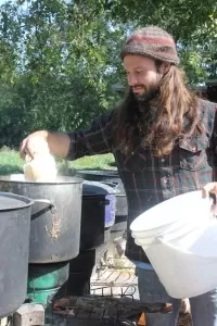 Adding clothing and fabric to pots for a pre-wash during our Natural Dyeing class | Homestead Honey https://homestead-honey.com