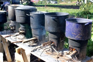 A row of Rocket stoves simmering natural dyes | Homestead Honey https://homestead-honey.com