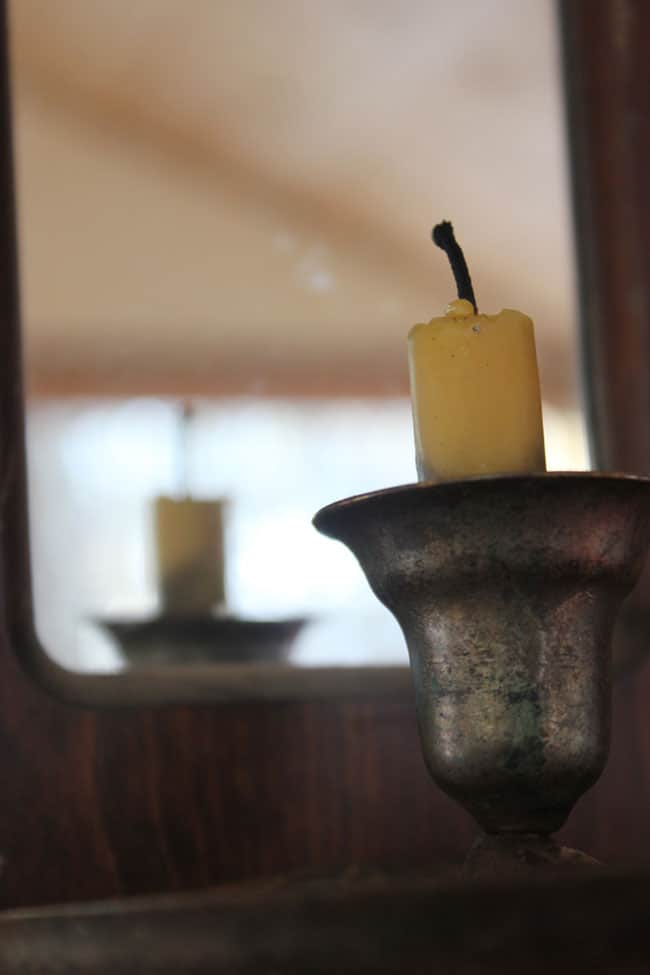 A trick for lighting with candles: Mirrors reflect light from a beeswax candle, helping to reflect light back into the room | Homestead Honey