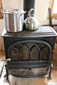 This wood stove does more than just heat our house! Inside its doors, a loaf of bread is baking! | Homestead Honey