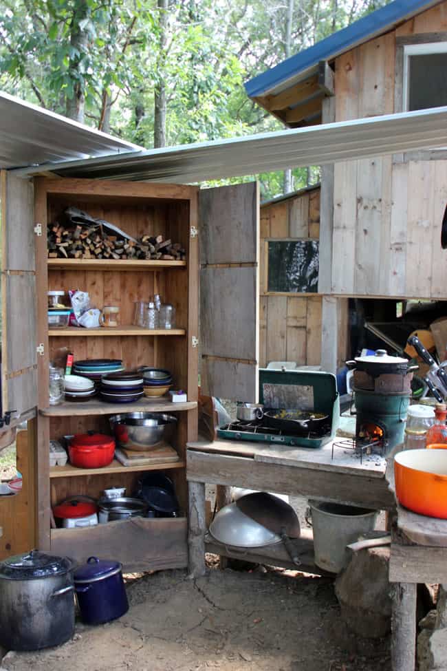 Our outdoor kitchen features storage space, a propane stove, and a rocket stove for cooking | Homestead Honey