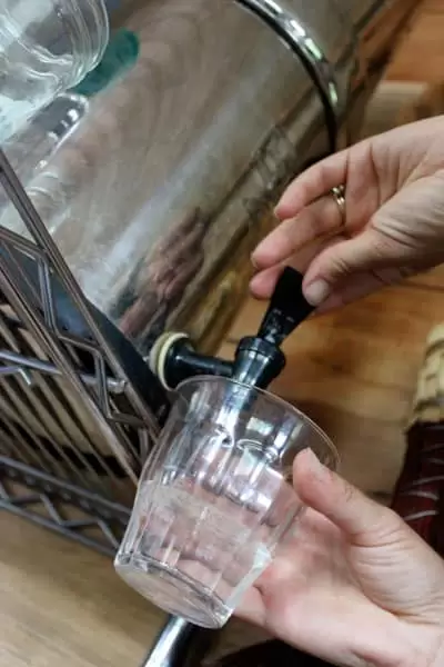 Drinking water being filtered through a Berkey filter for drinking and cooking makes it possible for us to drink clean water while living without running water