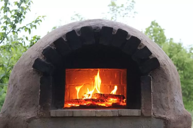 Wood stove with beautiful oven made of a mixture of cement clay and red  bricks 