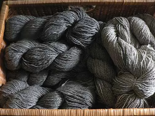 grey home raised yarn in a wicker basket.