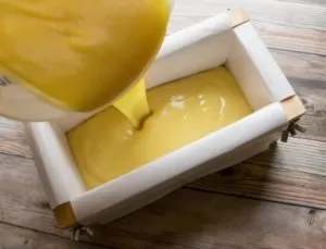 Pouring your calendula tallow soap into a mold