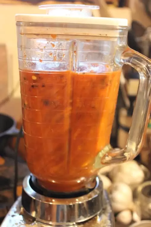 homemade fermented hot sauce being blended in a mixer until smooth