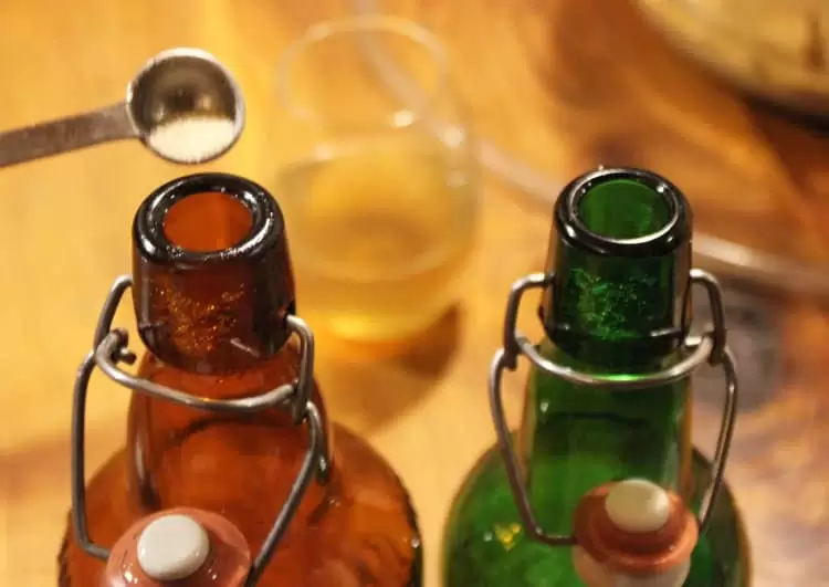 Adding priming sugar before bottling your homemade hard apple cider will create a sparkling beverage