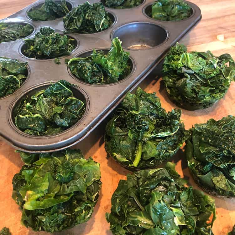 Kale can be frozen in muffin tins to make it easy to use in soups and stews later on!