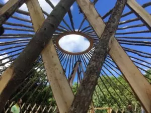 lattice walls and roof rafters of a 25 ft yurt