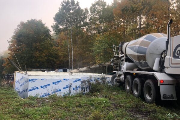 Concrete truck pouring our basement floor